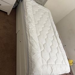 Twin bed with mattress and it has Drawers