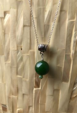 Jade pendant with sterling silver chain. 20 inches