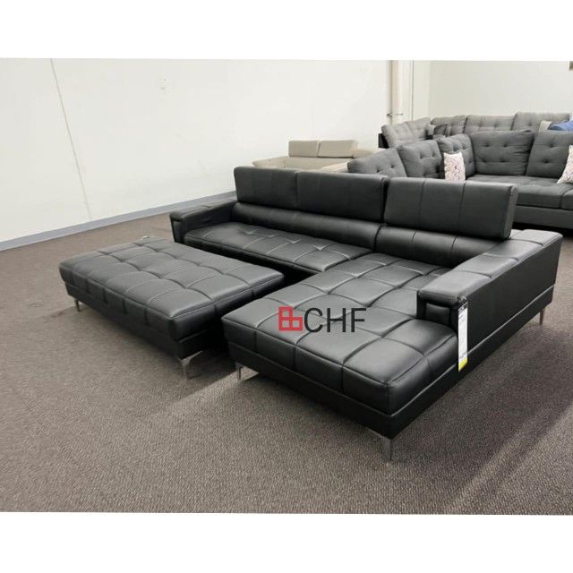 Black faux leather sectional sofa with ottoman