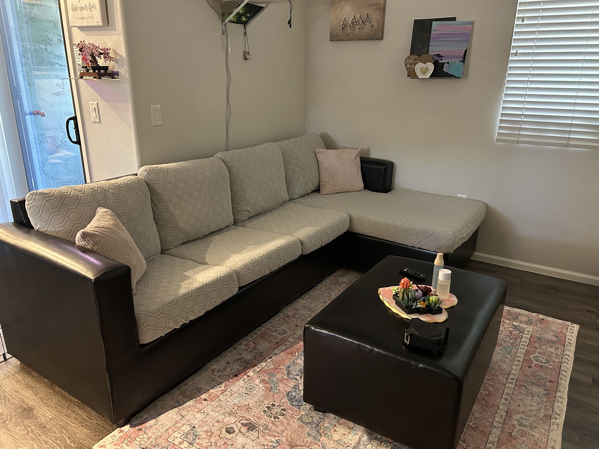 Black Leather And Light Grey Sectional With Center Ottoman