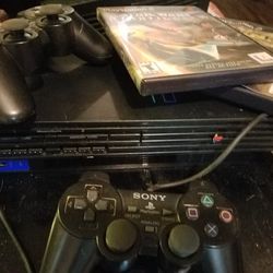 Playstation 2 with 2 controllers and 3 Games