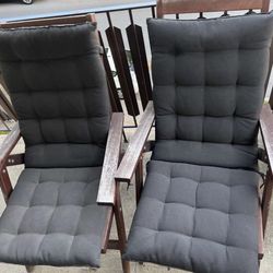 Two wooden patio chairs with cushions 