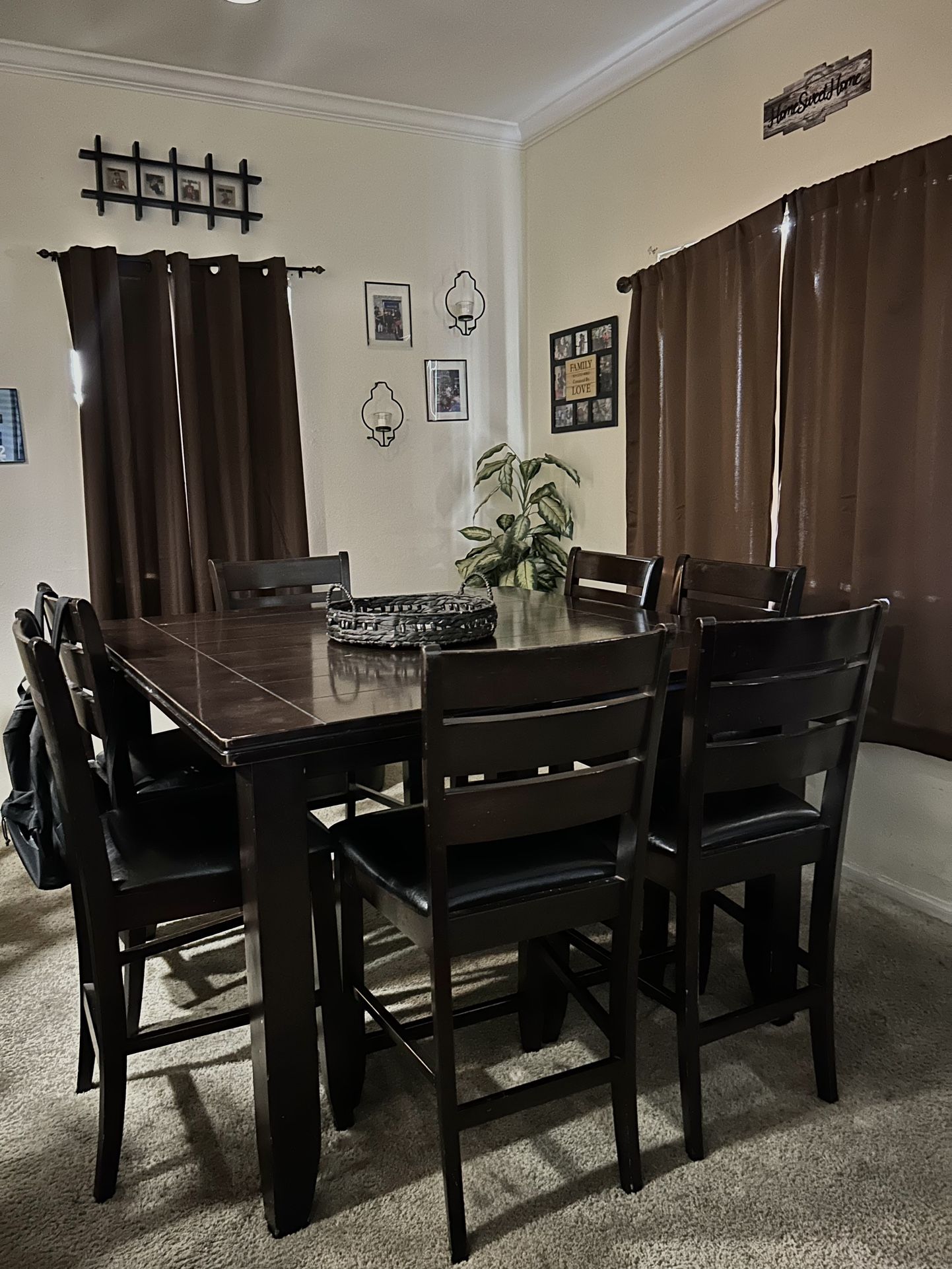 Dark brown wooden dinner table with chairs
