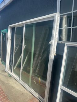 New construction white vinyl sliding glass door from DJ Windows & Doors. This unit has a  height of 80 inches  width of 95 inches. It is a double-pane