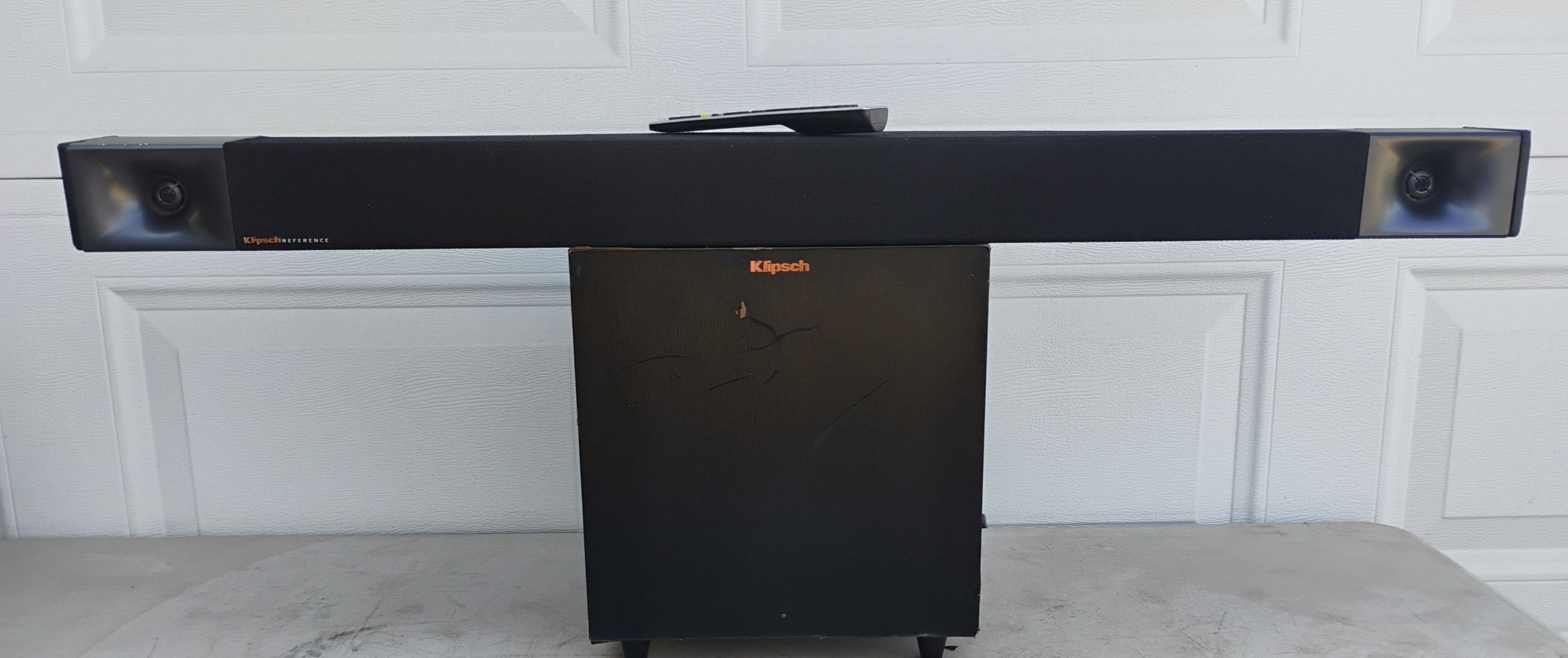 Klipsch Cinema 400 sound bar with Klipsch R-8SWi 8-inch 150W wired subwoofer and aftermarket remote.