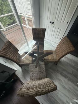 Woven chairs and glass table