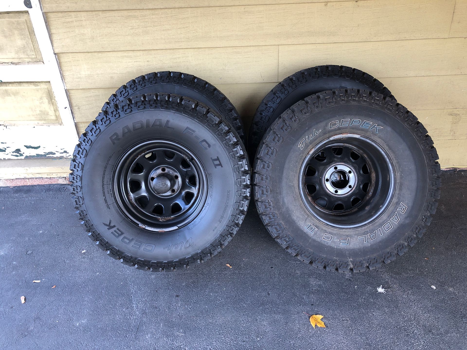 5 Dick Cepak 33x 12.5x 15 tires mounted on black steel rims. Jeep 5x4.5 bolt pattern. Local pick up only