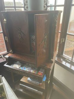Antique tall storage cabinet with claw feet and brass goddess detail