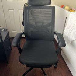 black mesh office chair with footrest and wheels