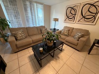 Beige Sofas, coffee table and a lamps
