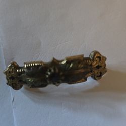 A Gold Metal Pin With Amethyst