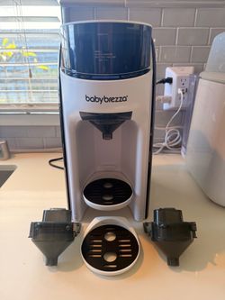 Baby Brezza Formula Pro with extra funnels and trays