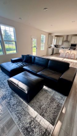 Black leather chaise sectional with ottoman