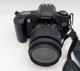 Classic Canon EOS Rebel G film camera. Has a Tamron 28-80mm lens.