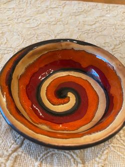 Handmade Earthworks ceramic pottery swirl bowl featuring striking orange multi swirl design. Small.