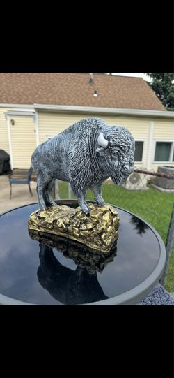 The gray and gold buffalo statue