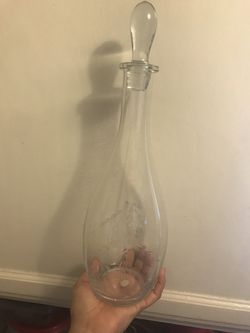 Decanter with etched design on it.