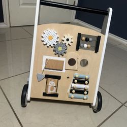 wooden baby walker with a multi-activity center.