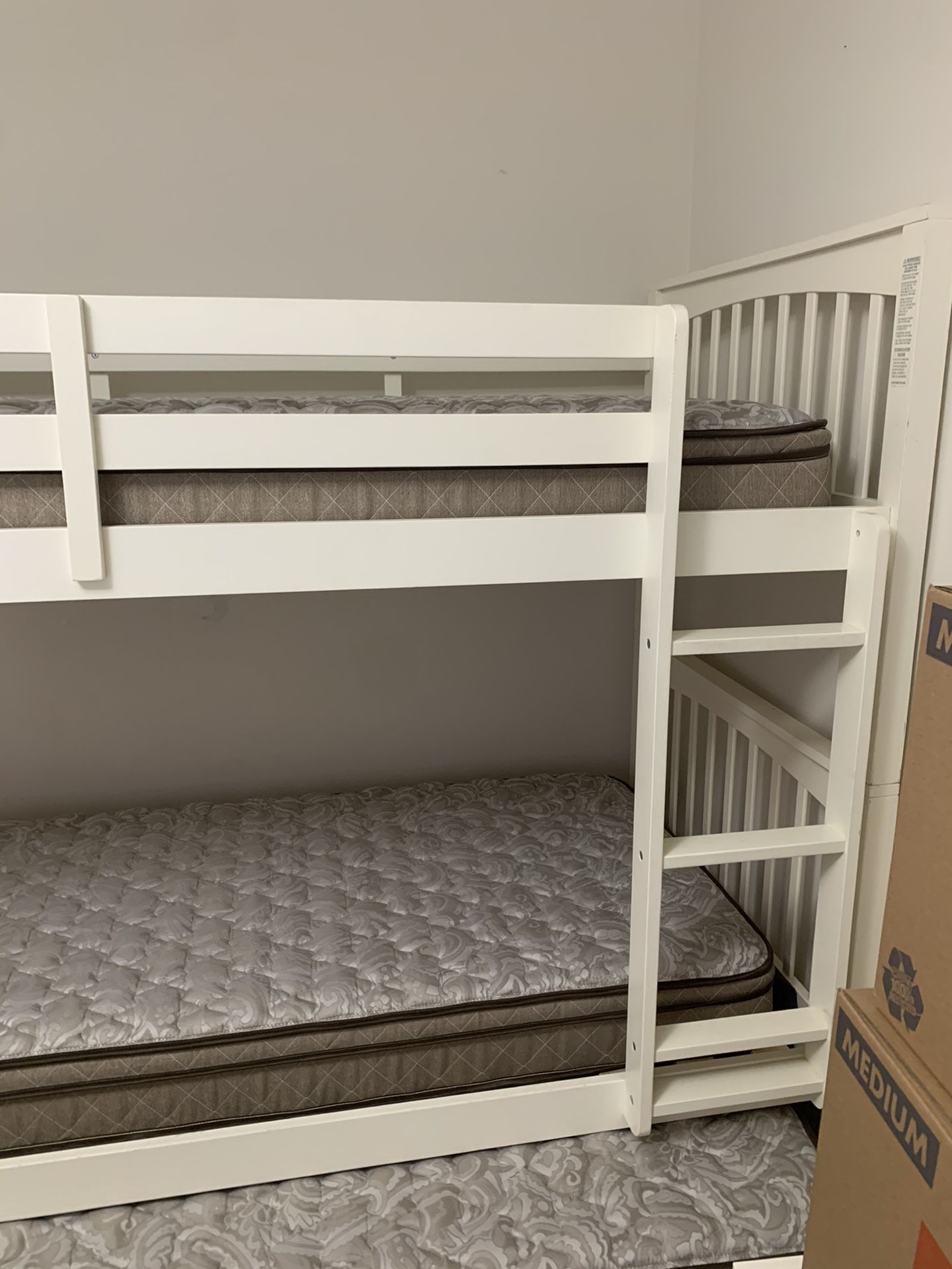 Raymour and Flanigan bunk bed with trundle and brand new mattresses. 1 year old.