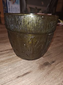 This is a vintage 1970s green glass planter