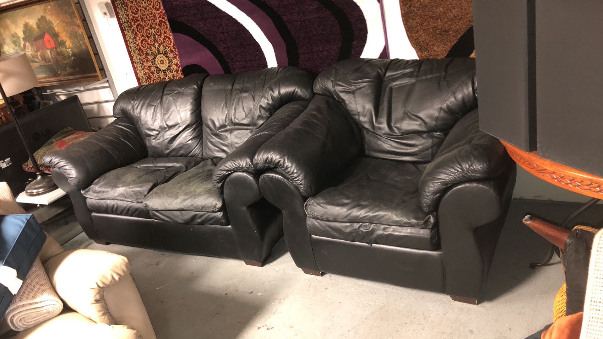 Black leather loveseat and single chair