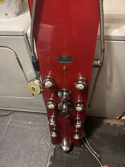 Modern multi-function shower panel with tempered glass front and stainless steel fixtures. Includes overhead rain shower, multiple body jets, handheld