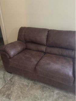 Brown loveseat and a couch