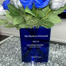 Blue book shaped flower vase and roses