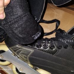 Hockey Skates And Two Sticks, One Stick Is Reebok And The Other I Believe Is Reebok/Nhl