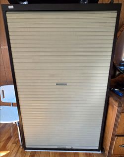 Mega brand tambour door storage cabinet with a vertical roll-up shutter.