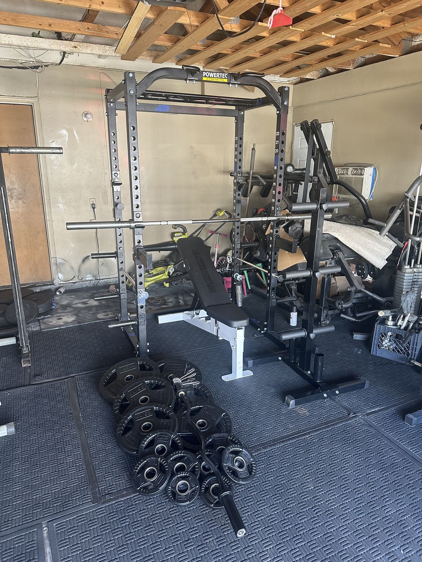 Powertec bench press/squat rack with 7ft 45lbs bar plus 255lbs of rubber coated weights plus curl bar and weights tree