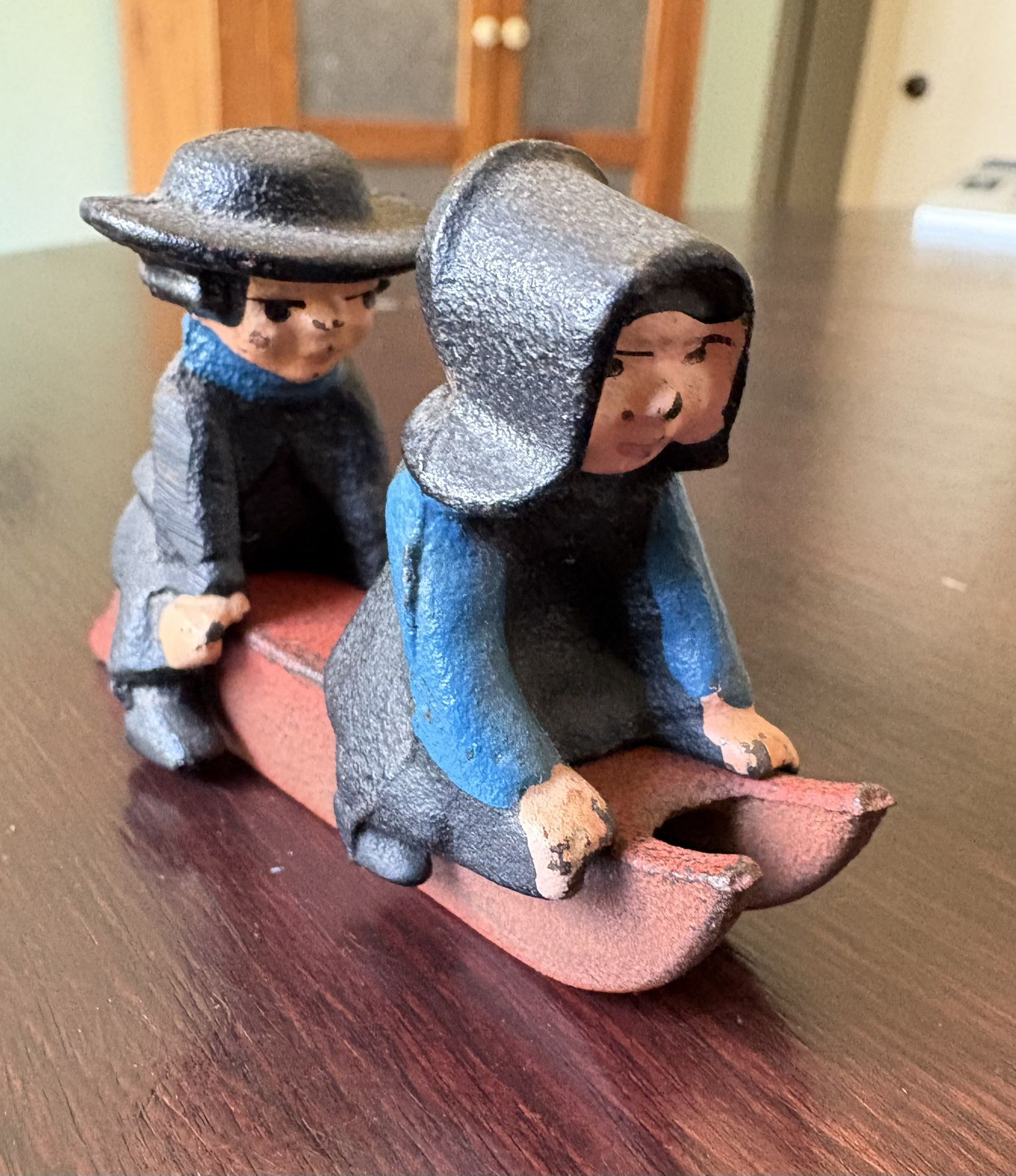 Vintage Cast Iron Amish Couple Sledding Figurines