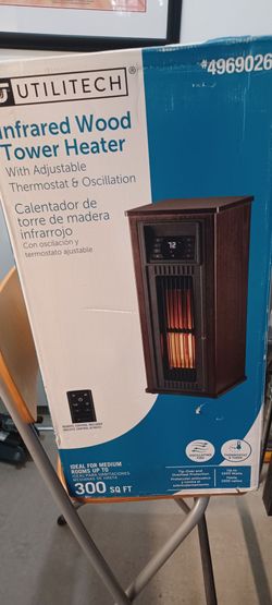 New The Utilitech 1500-Watt Infrared Tower Indoor Electric Space Heater HT1218N is a dark walnut
