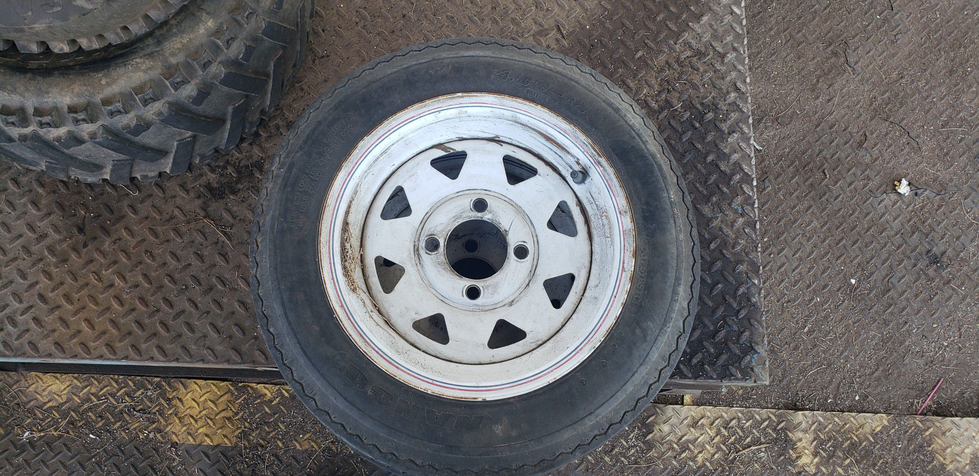 Two 4 lug trailer rims and tires Size 4.80 -12