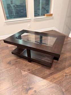 Wood and glass coffee table with wheels