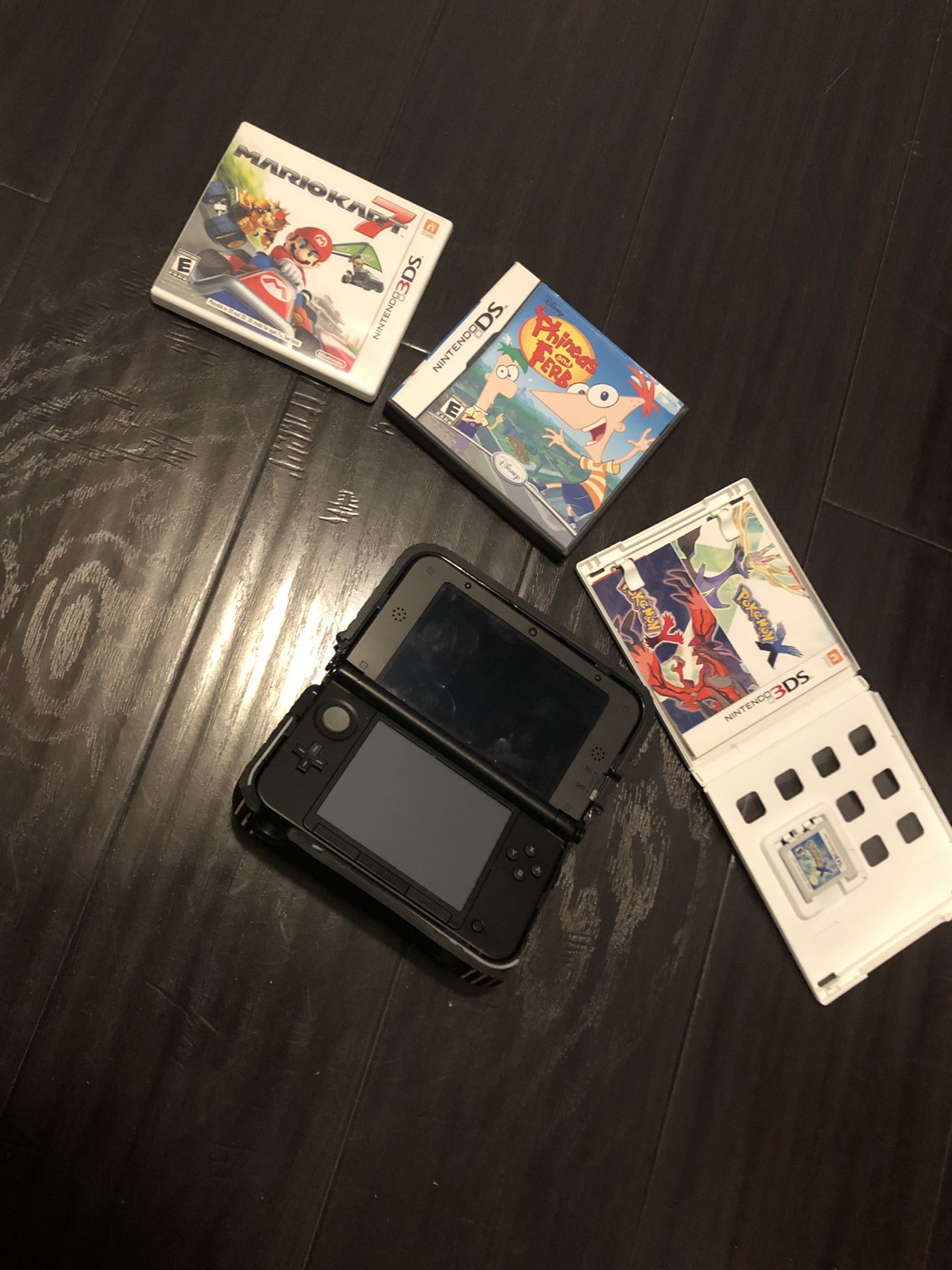 Nintendo 3DS with nerf case and games.