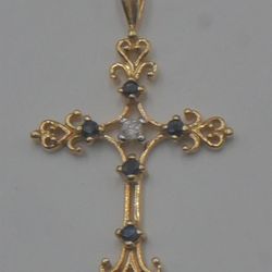 1OKT YELLOW GOLD CROSS PENDANT 1.6 GRAMS 1 DIAMOND 0.05PTS  & 5 SAPPHIRES  MINT .