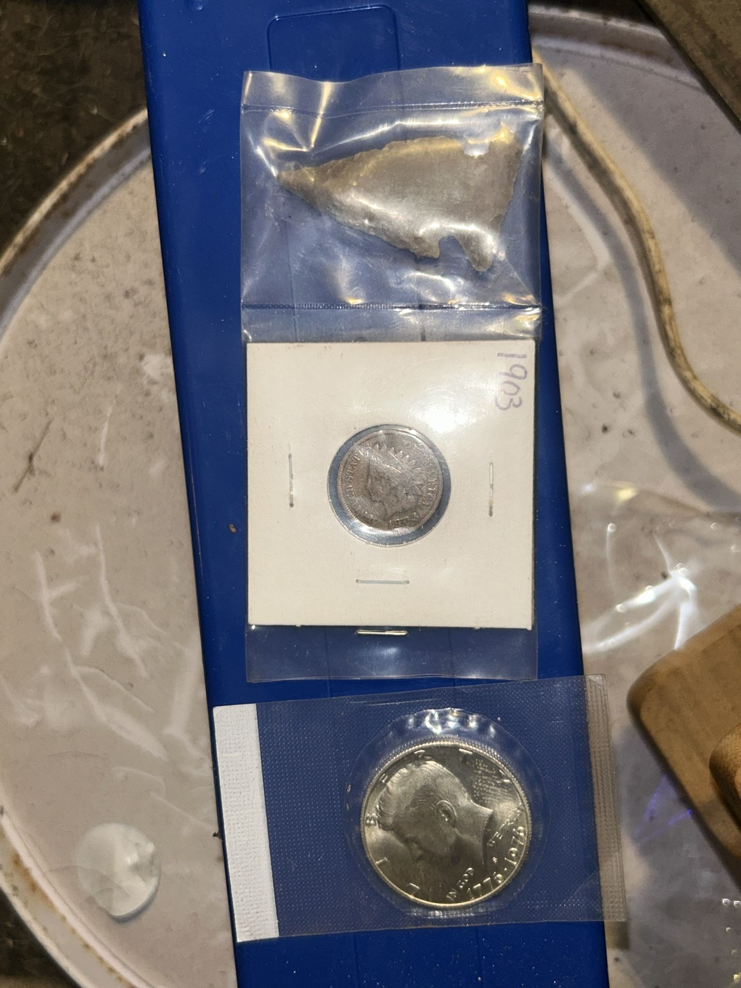 A 1903 Indian one cent penny with an authentic arrowhead a uncirculated silver