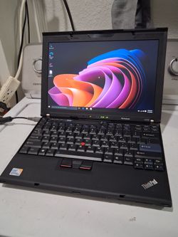 Lenovo ThinkPad laptop computer.  14 inches screen.  Windows 10.  Battery doesn't charge,  but it works good plugged.   Intel core 2 duo CPU processor