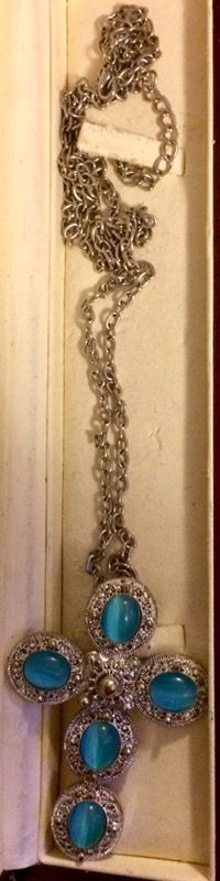 Silver cross necklace with turquoise stones.