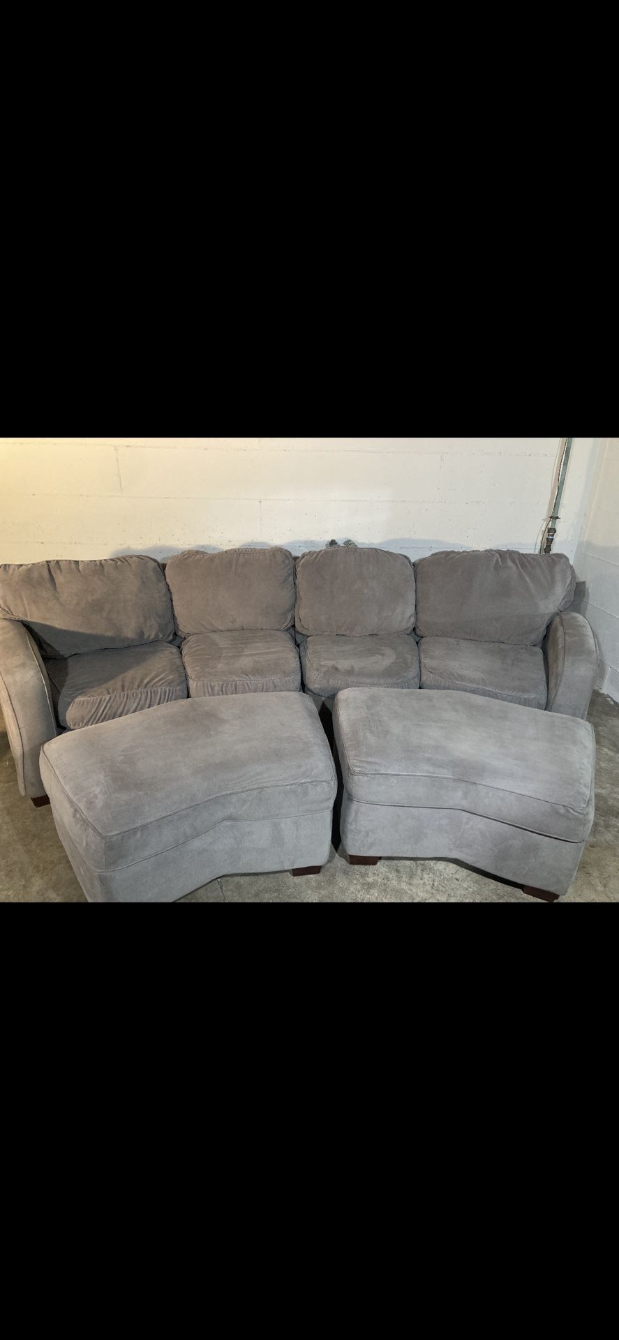 Light olive green 2 piece 2 ottoman curved sectional by Furniture Fair.