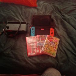 Nintendo Switch 1 With Traveling Case , Standing Charger , 3 Games And Console With 2 Remotes . 