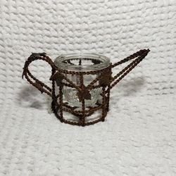 Metal wire water can tealight burner. Rust color measures 3 1/2" T X 6 3/4" L . Good condition. 