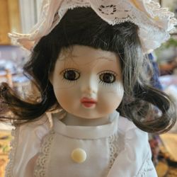 Collectible vintage porcelain and wind-up musical doll