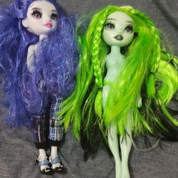Two Dolls And A Bag With  Random Clothes 