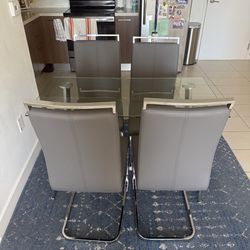 Glass table and 4 leather chairs