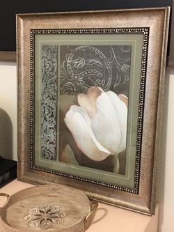 White locus and teal green picture with gold frame