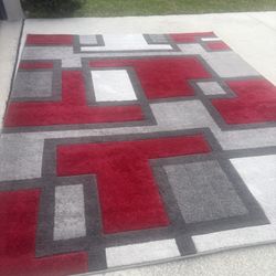 Geometric area rug in three colors (red, white, and gray), 7.9 x 9.8 feet. Used for a short time, in perfect condition.
