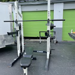 Half rack with pull up bar and dips/ 255lbs of grip olympic plates and barbell/ bench home gym 