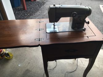 Domestic sewing machine in brown frame